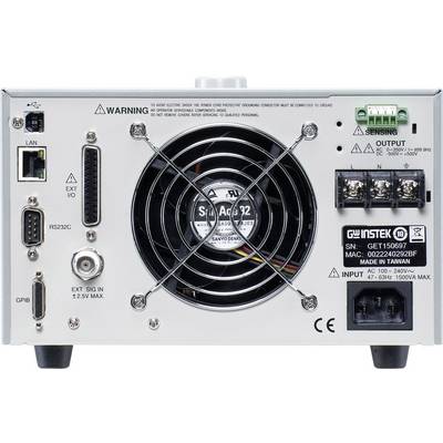 Back of a power supply unit with a fan in the centre, various connections and switches. Label with technical specifications and warning notices on the right.