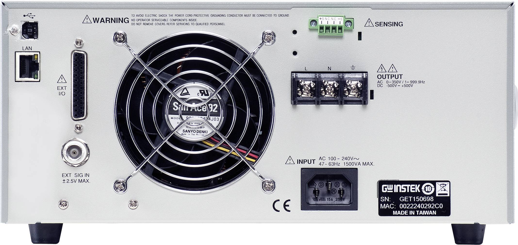 The back of an electronic device shows a fan, connection sockets, power connection, and warning notices. Model name bottom right.