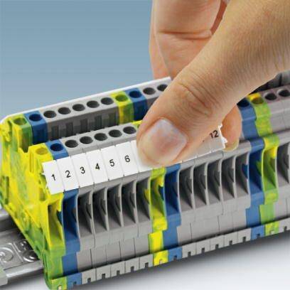 A hand is numbering cable connectors in an electrical terminal block. The numbers range from 1 to 6.