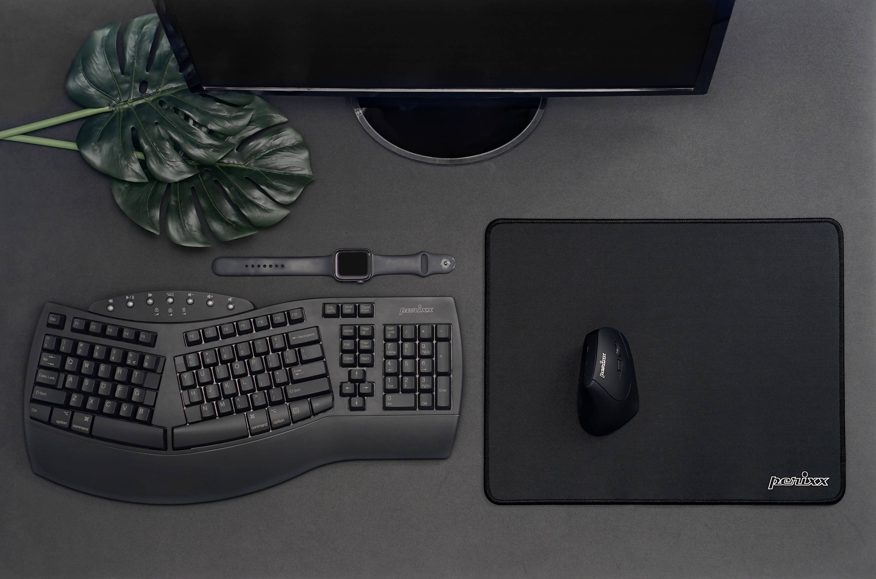 An ergonomic black keyboard and mouse set on a desk with a grey background, positioned next to a small plant decoration.