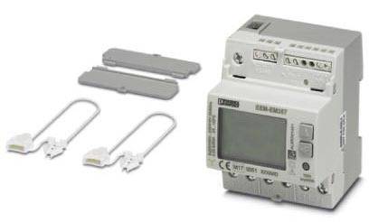 Electronic meter with digital display and control elements. Two covers and connection cables are placed beside it. Device for energy monitoring.