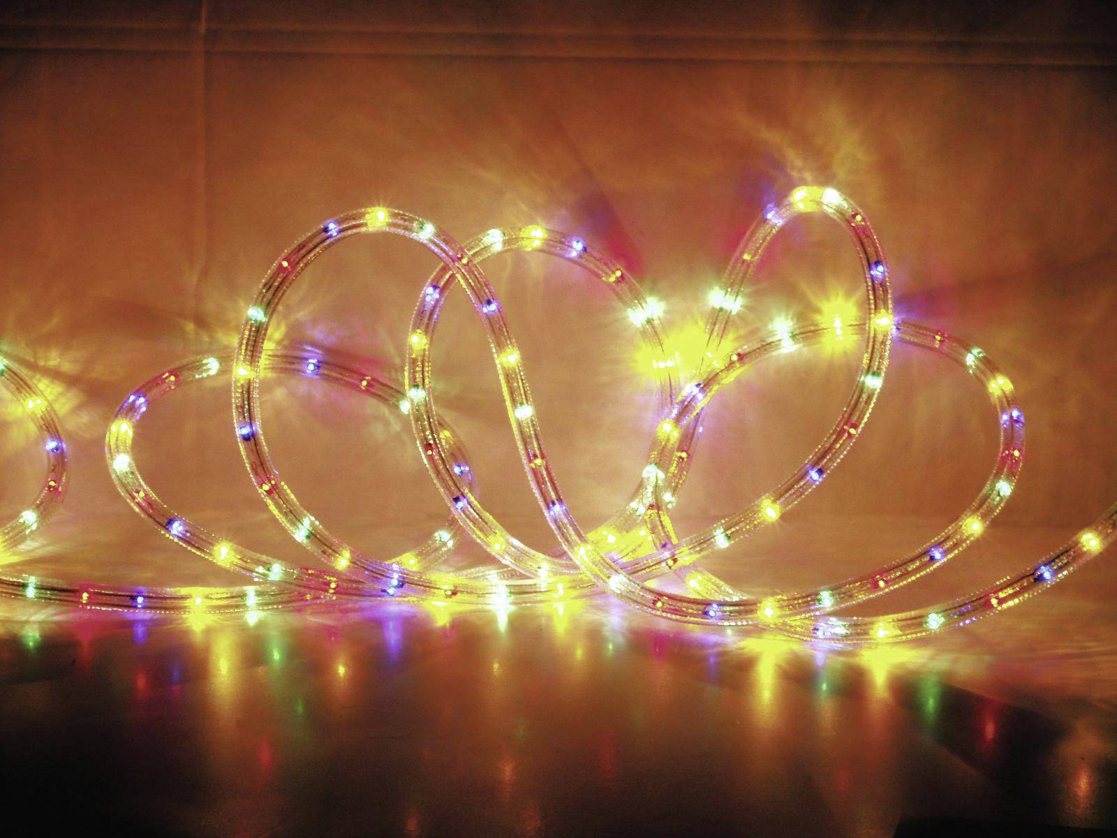 Luminous, colourful LED light tube on a dark background, contributing a decorative, wave-like arrangement to the atmosphere.