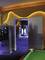 An open doorway leads from a room with neon lighting into another. The walls are painted in vibrant colours.