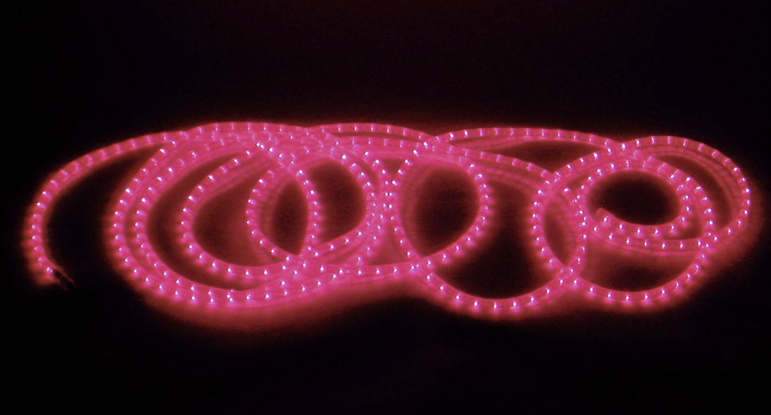 Red fairy lights arranged in spirals on a dark background, creating a atmospheric glow.
