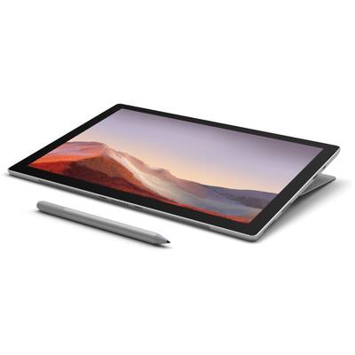 A tablet with a detachable keyboard and stylus pen lies at an angle on a table. A mountain landscape is visible on the screen.