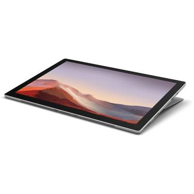 A slim, silver laptop with a display showing a landscape of red mountains at sunset.