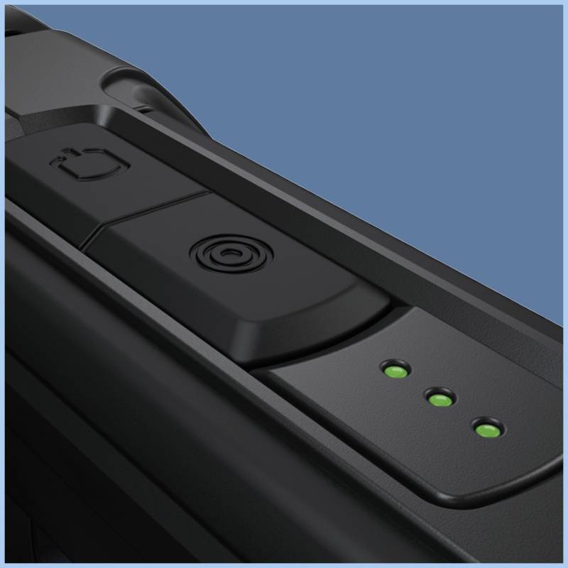 A close-up of a black electronic device with green LED indicators and a button on a blue background.