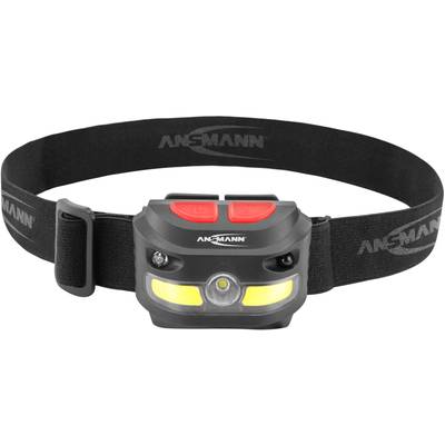 Head torch with black headband, two red buttons and yellow illumination unit. 'Ansmann' brand visible on the lamp.