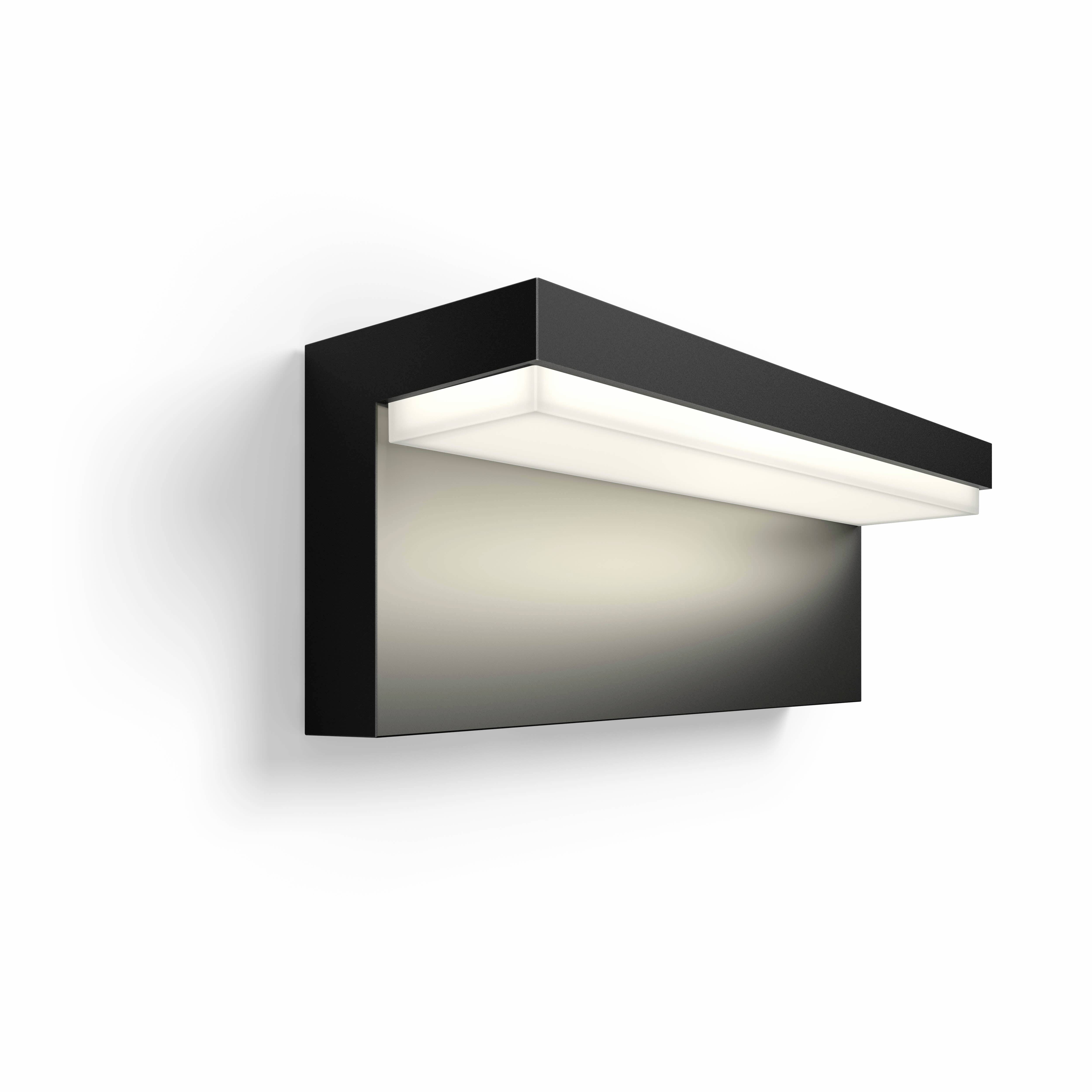Black rectangular wall lamp with LED strip illuminating upwards, mounted on a light-coloured wall. Minimalist design.