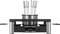 An electric fondue set with eight differently coloured forks, placed on a table. Perfect for sociable meals.