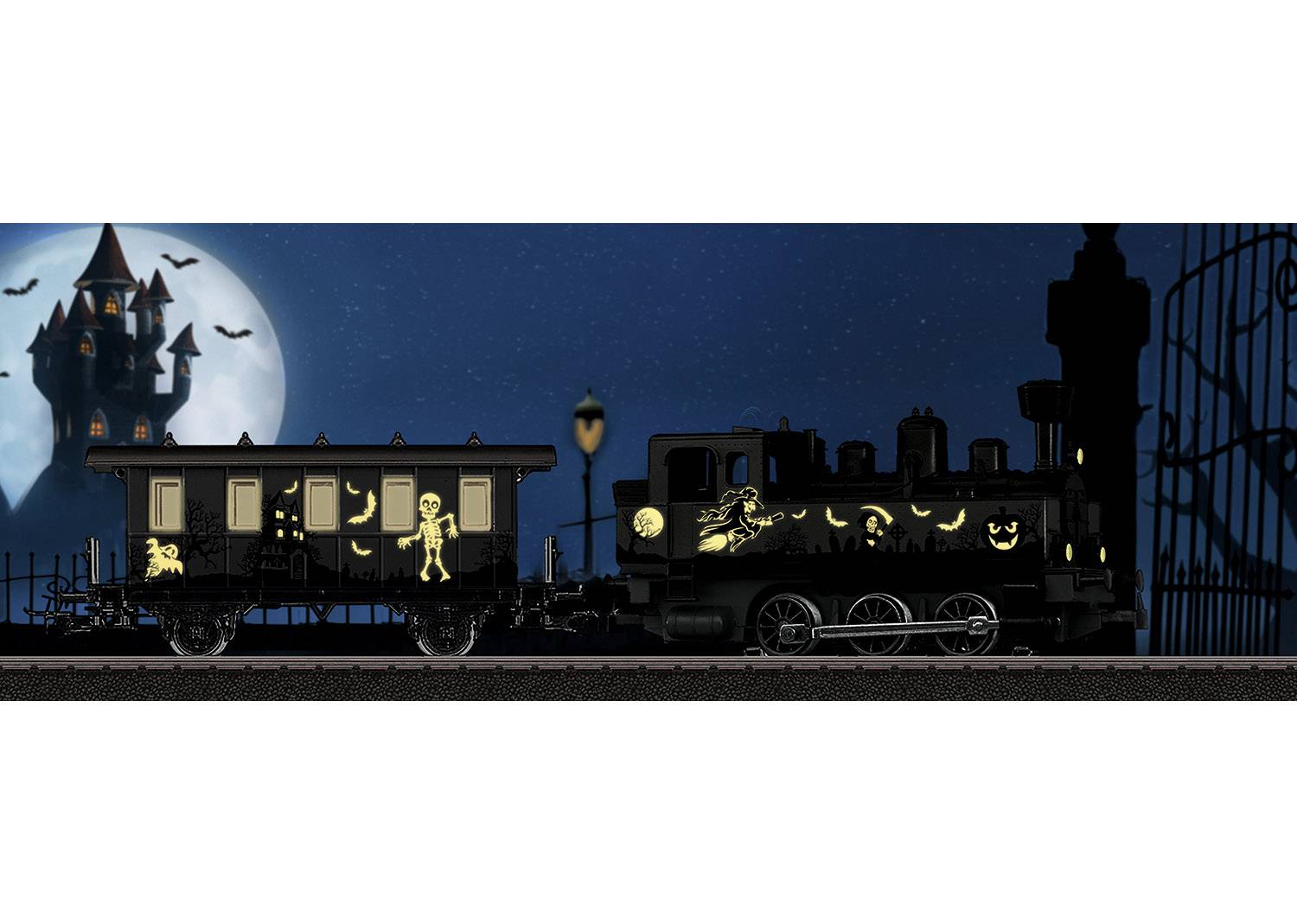 A train with glowing Halloween motifs, such as a pumpkin and a skeleton, travels at night. In the background, an illuminated haunted castle.