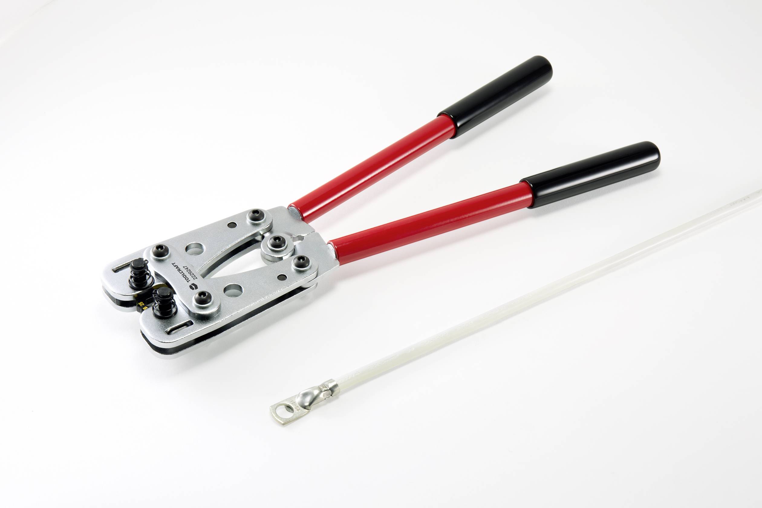 Pliers with red handles and a cable connector on a white background. Used for crimping cables or metal wires.