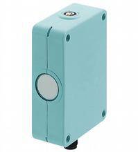 A rectangular, blue electronic device with a round button in the centre.