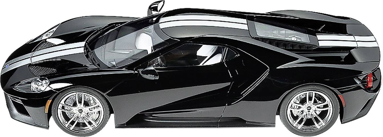 Black sports car model with white racing stripes, viewed from the side. Elegant design with glossy surface and stylish wheels.