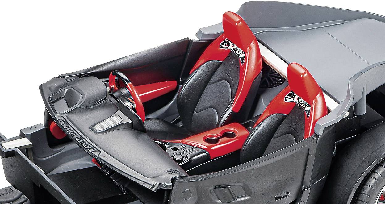 The interior of a vehicle model with two red seats, black dashboard, and steering wheel.