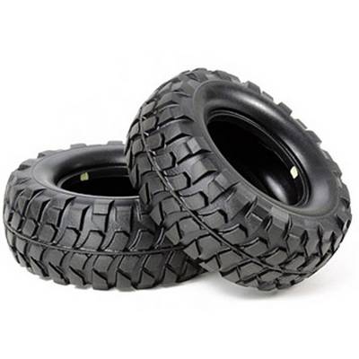 Two robust black tyres with pronounced treads, stacked on top of each other, on a white background.