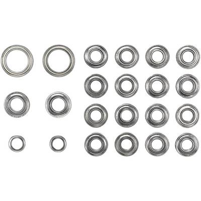 Different-sized ball bearings on a white background, viewed from above.