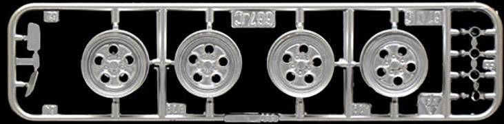 Plastic model casting frame with four round parts; details such as numbers and shapes are visible, typical of model kits.