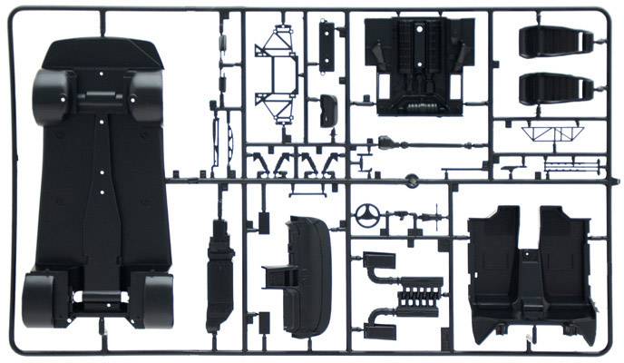 Kit frame with black plastic components for a toy car. Parts include bodywork, seats, and axles for assembly.