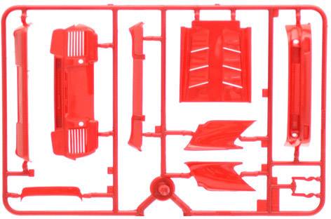 Several red plastic parts on a casting frame that need to be assembled. The parts resemble components of a model car.