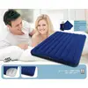 A couple is lying smiling next to a blue, inflatable air mattress. Oxygen pump in the background. Dimensions: 1.52m x 2.03m x 22cm.