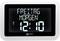 Digital clock with a black background shows 'Friday Morning' and the time '12:10'. A small DST symbol is located in the top left corner.