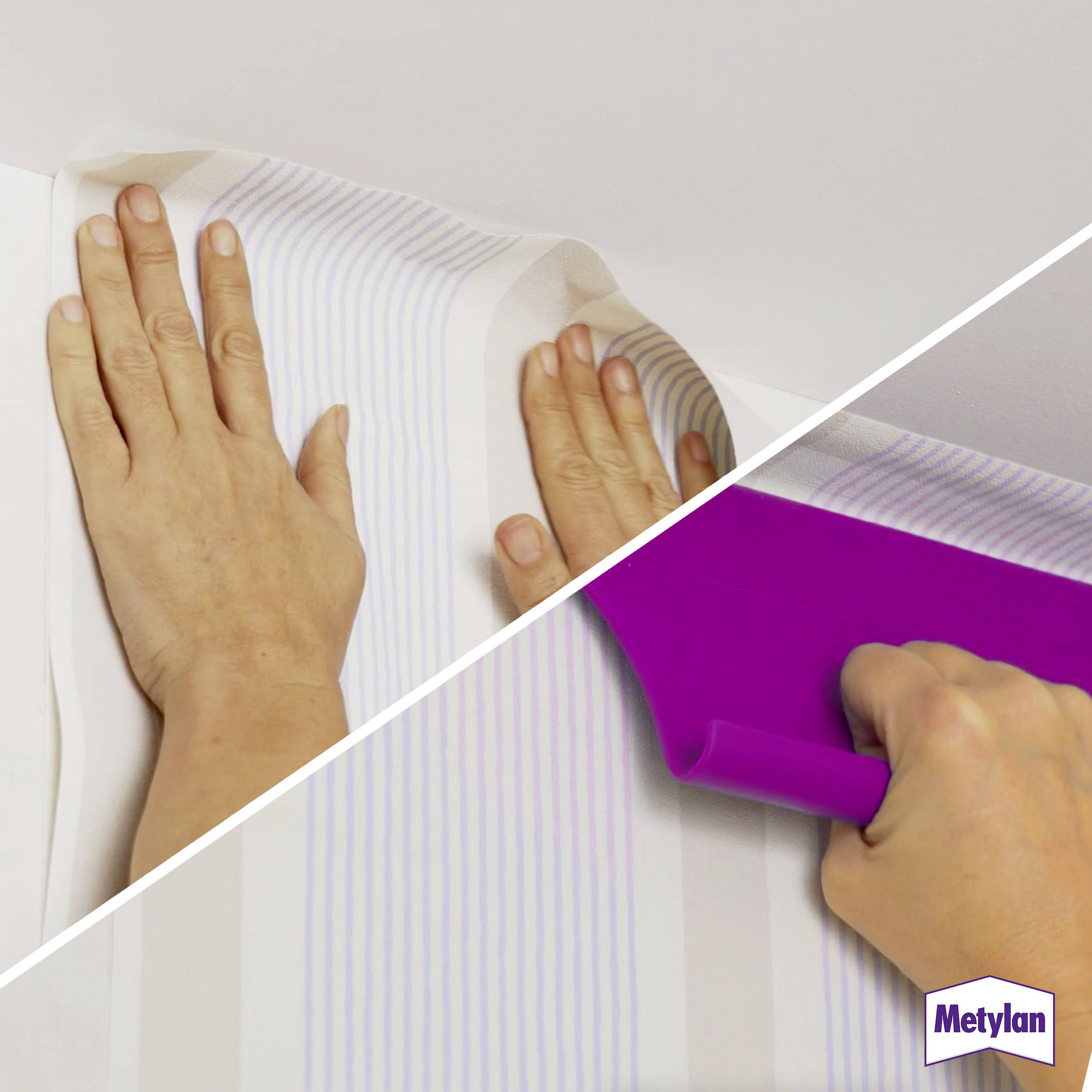 Two hands smooth wallpaper stripes onto a wall. Another hand uses a purple tool to straighten paper edges. Metylan logo in corner.
