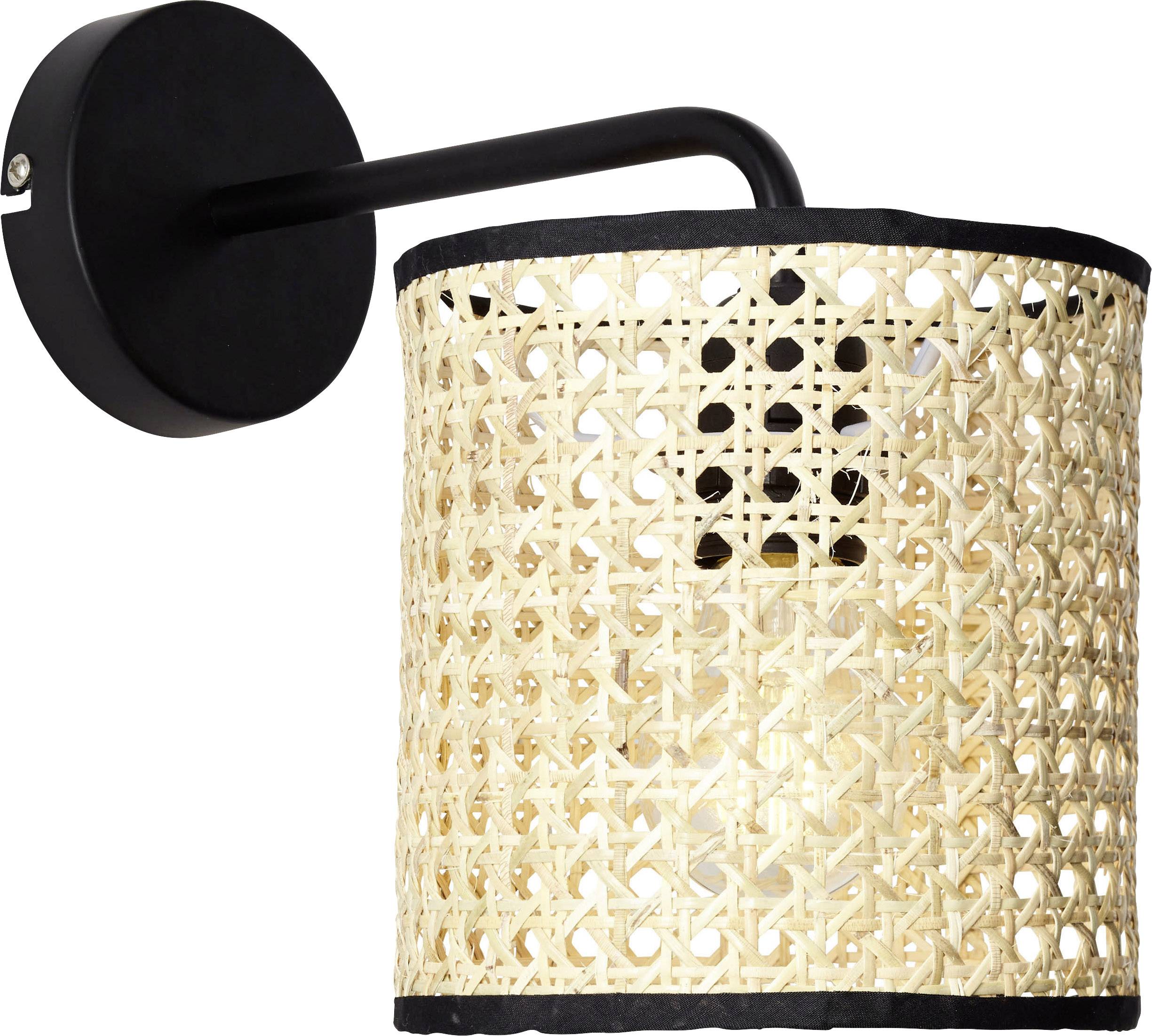 Wall light with a black frame and a woven, round lampshade made of rattan, which provides warm light.