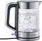 Glass electric kettle with metal accents, water boiling inside. 'Severin' brand name visible on the base.