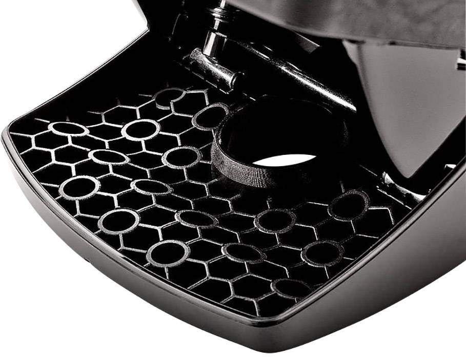 Close-up of a black coffee machine drip tray with a honeycomb-shaped pattern and a round drain in the centre.