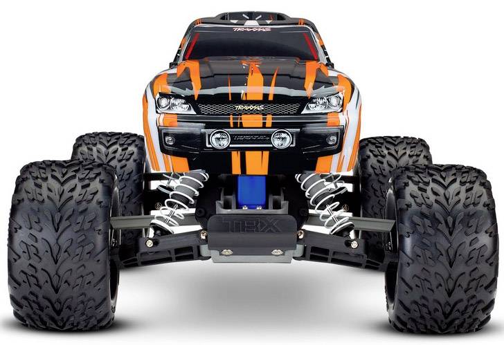 A remote-controlled car with large, grippy tyres and an orange flame pattern on the bodywork.