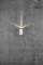 A silver wall light illuminates upwards and downwards onto a grey concrete wall with visible cracks.
