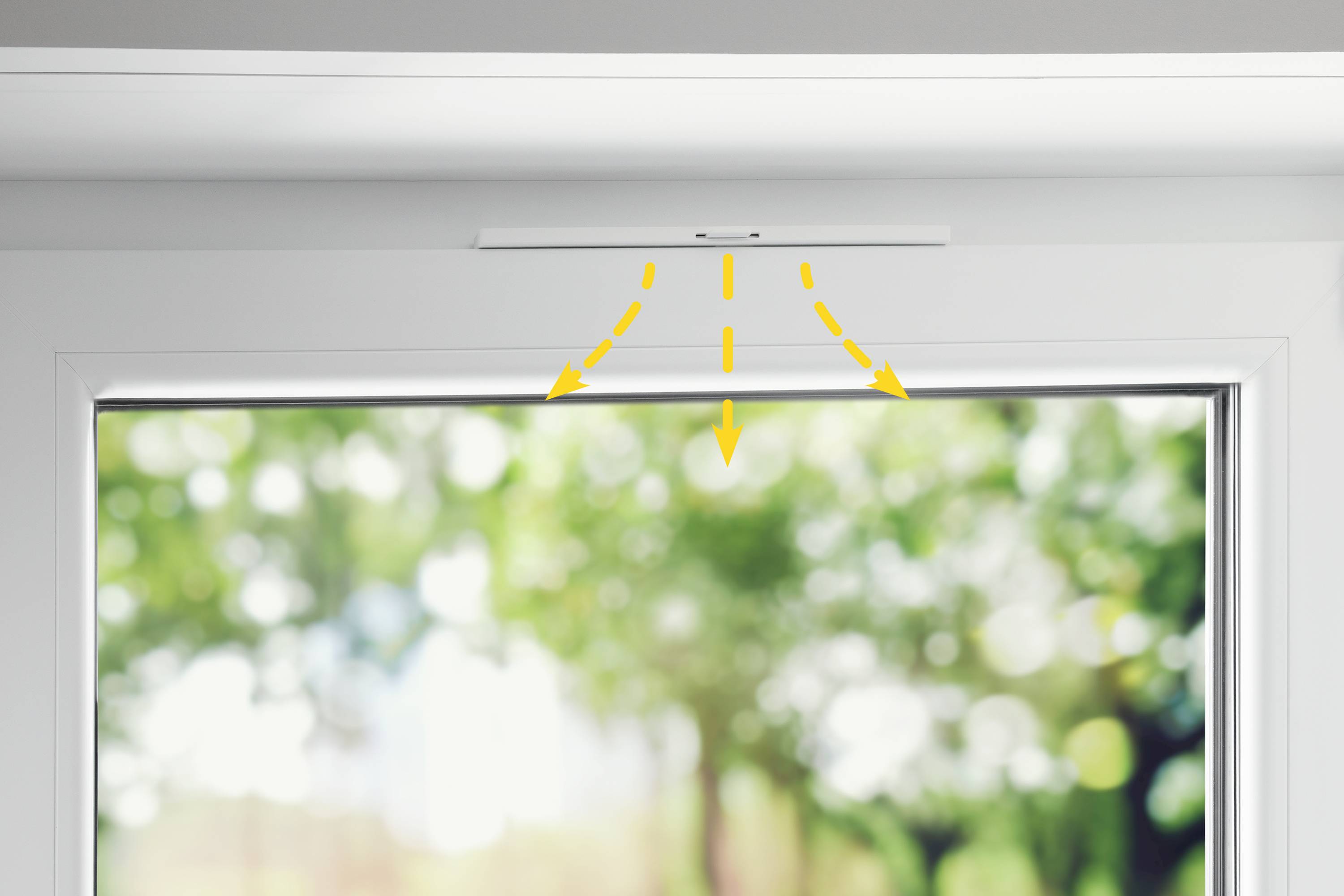 Yellow dashed lines indicate a ventilation slot above a window, allowing fresh air into the room. Background blurred.
