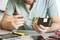A man is repairing a smartphone with a screwdriver and showing the opened interior of the device.