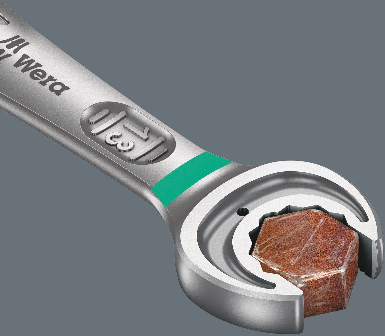 A silver adjustable spanner with an open head is holding a rusty-red bolt. The handle is marked with a green indication.