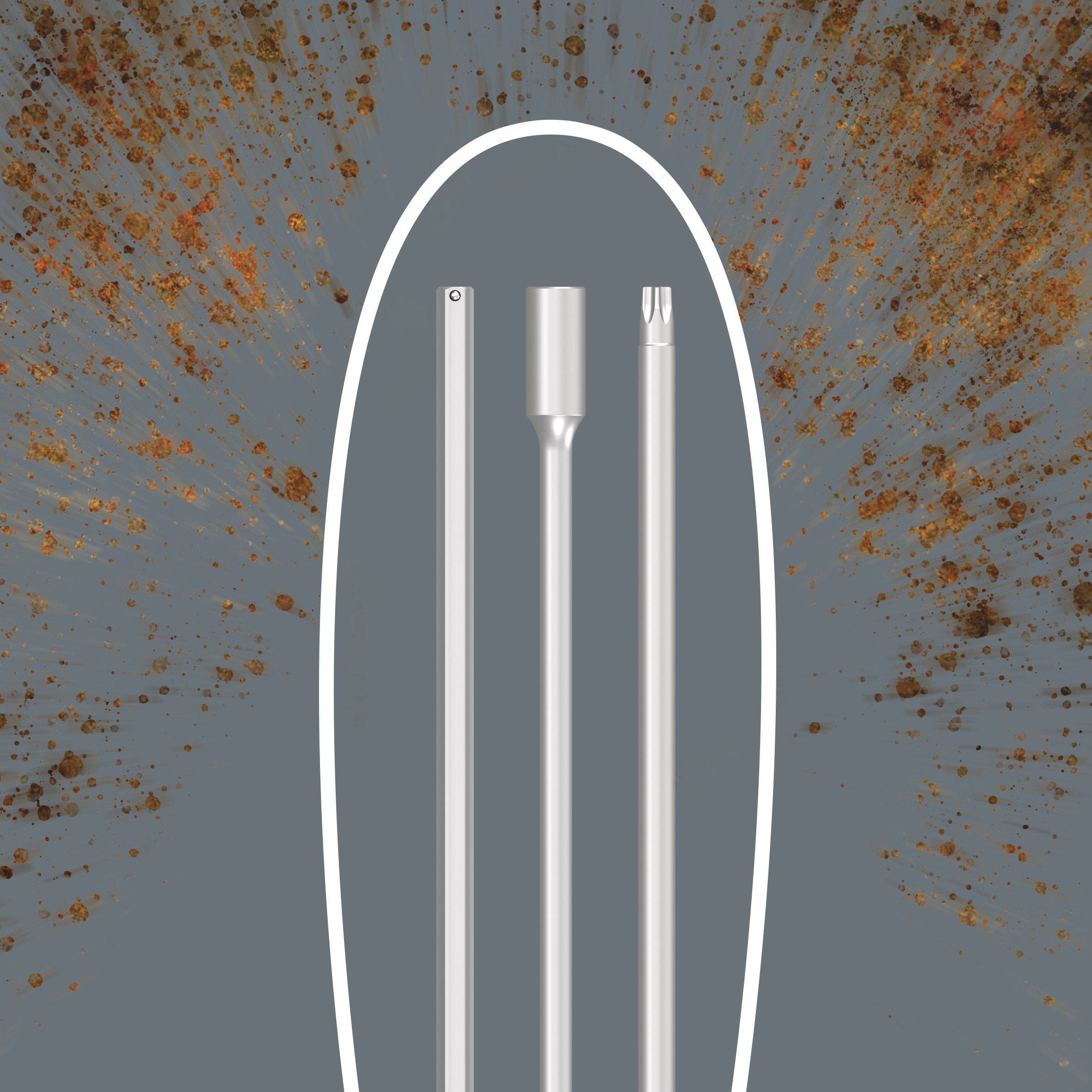 Three differently shaped metal bars against a rust-coloured background, possibly tools or components.