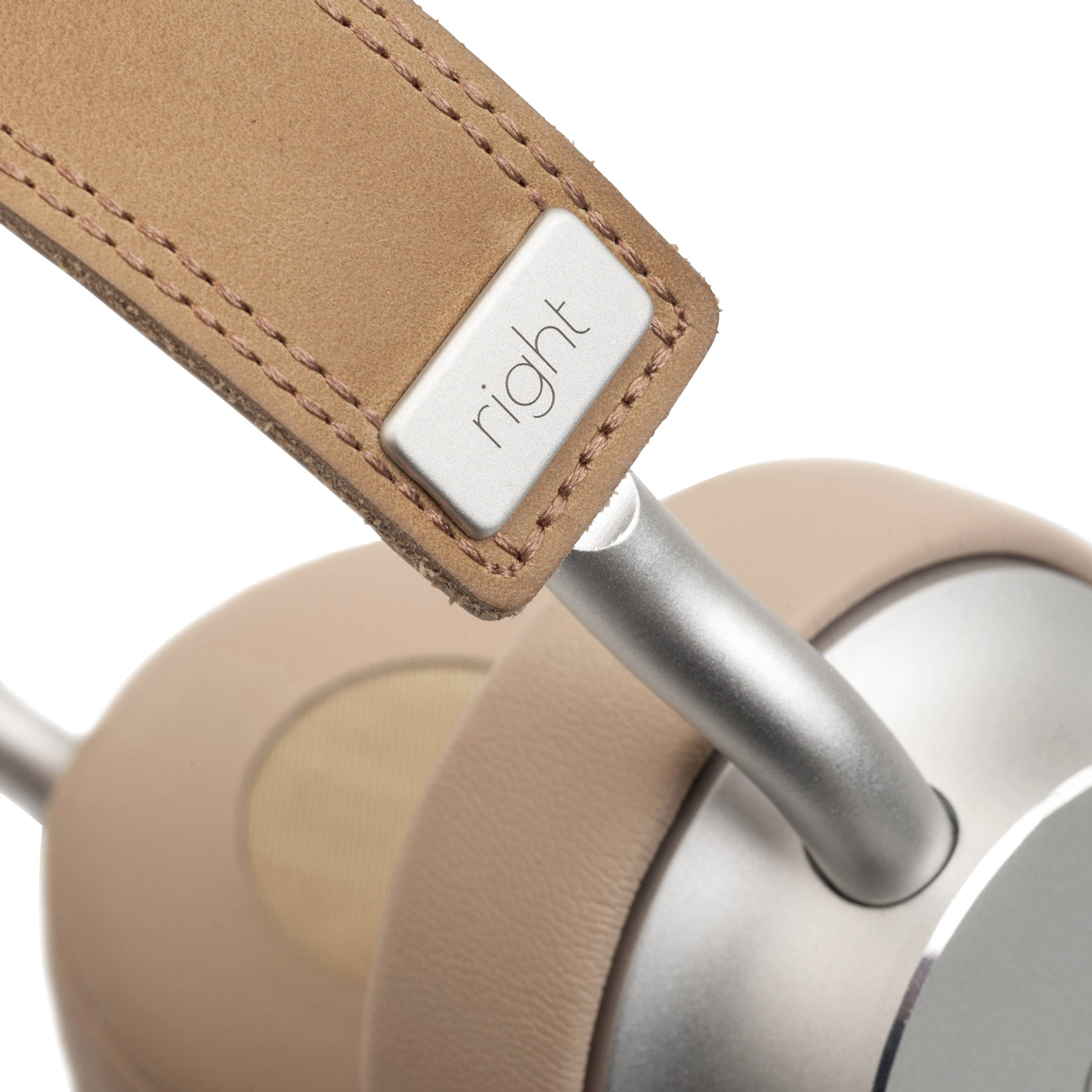 Close-up of a headphone with a leather headband and metal connection, with 'right' written on it.