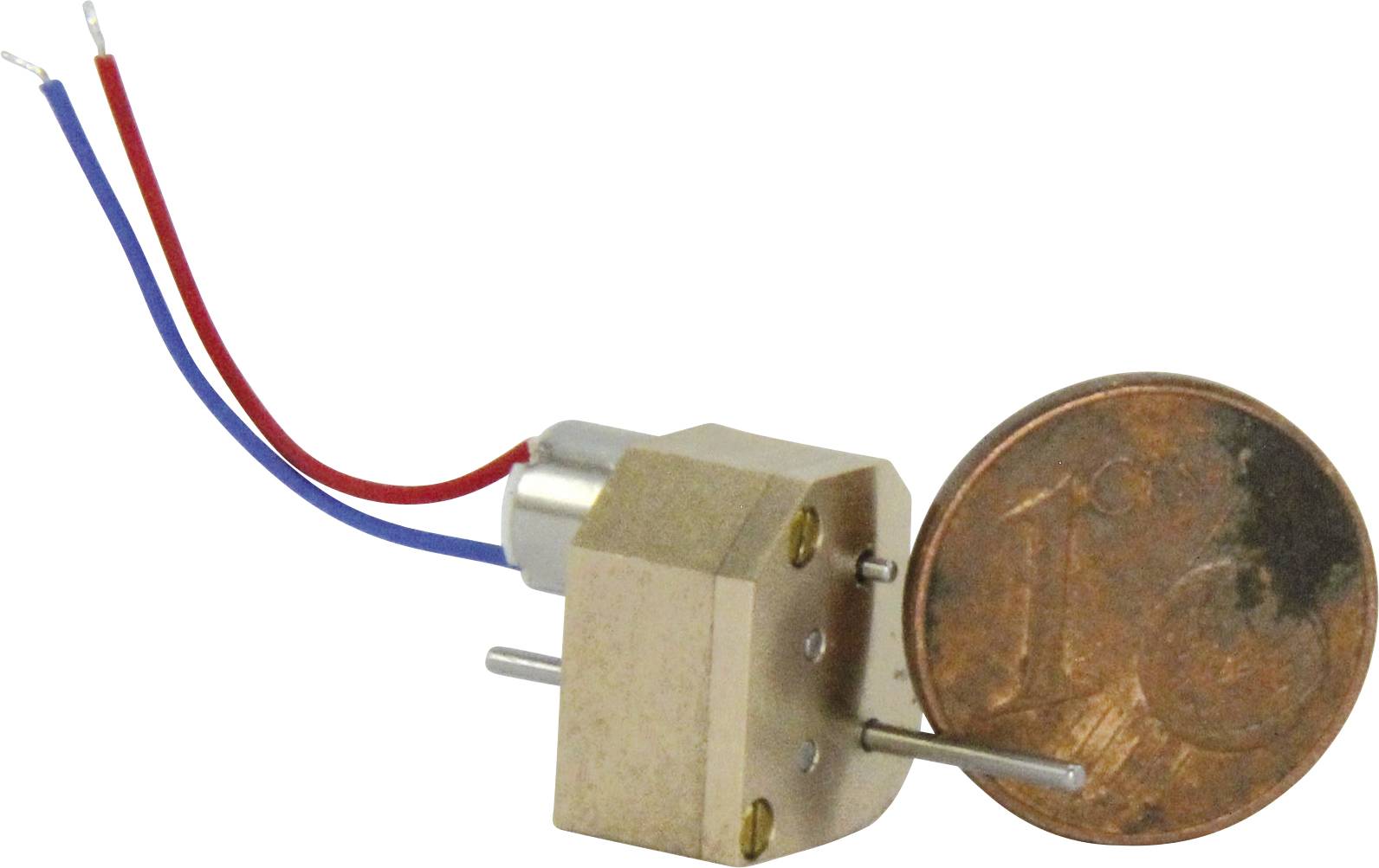 Small motor next to a one-cent coin for size comparison, with red and blue cables attached to the motor.
