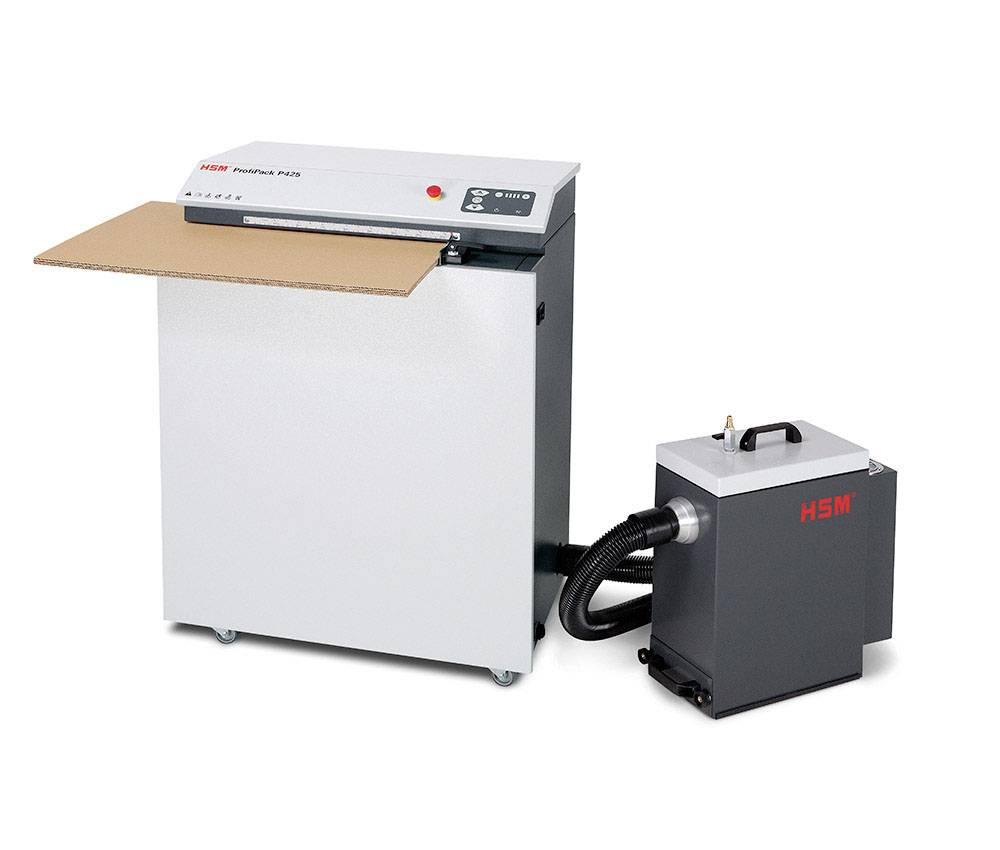 Industrial packaging machine with a cardboard roll on top, connected to a separate extraction container. 'HSM' brand logo visible.