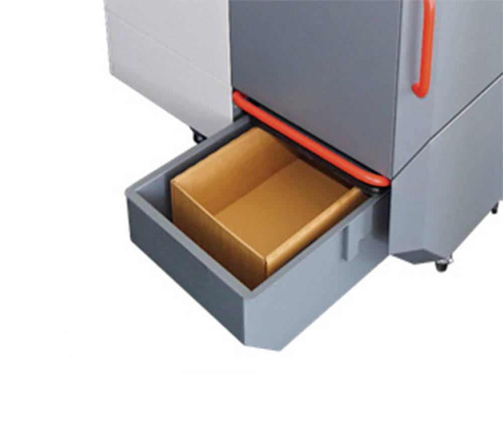 An open cupboard with a pulled-out drawer containing an empty brown cardboard box.