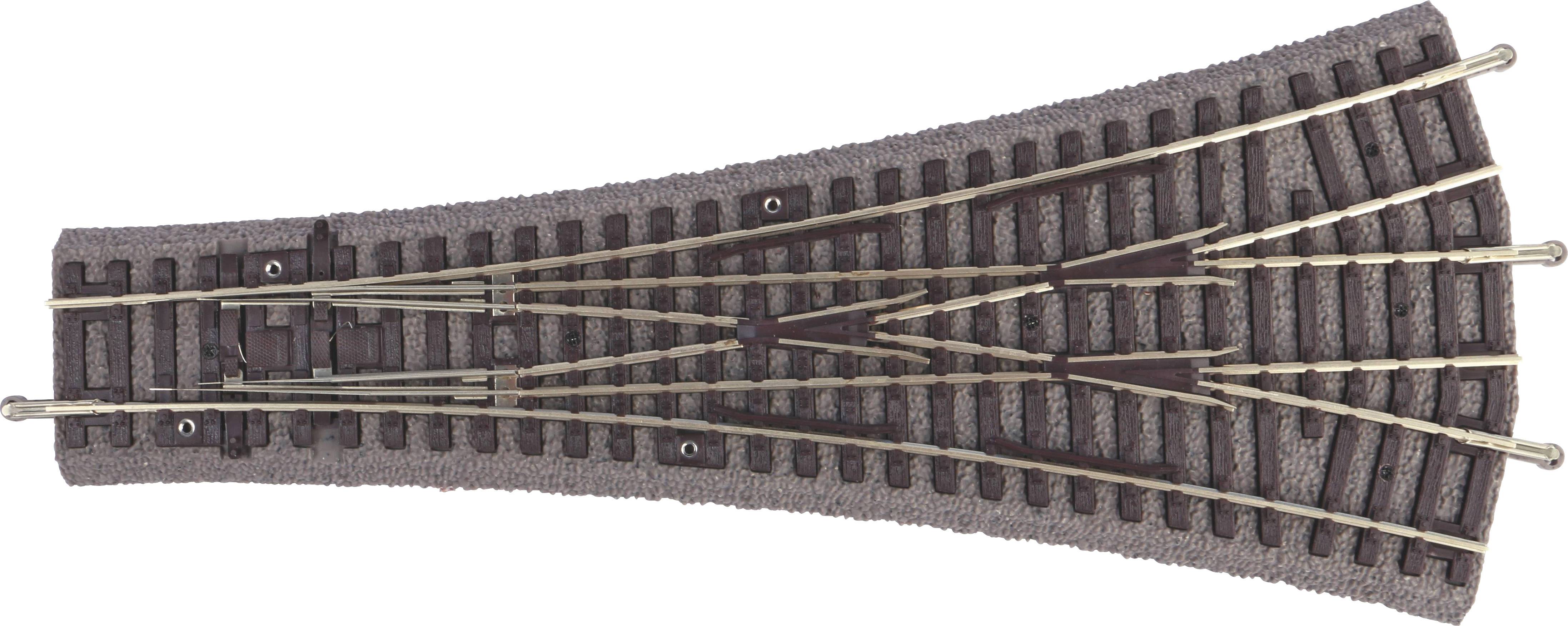 Points for a model railway, representing a track junction. It displays complex metal struts on a brown track base.