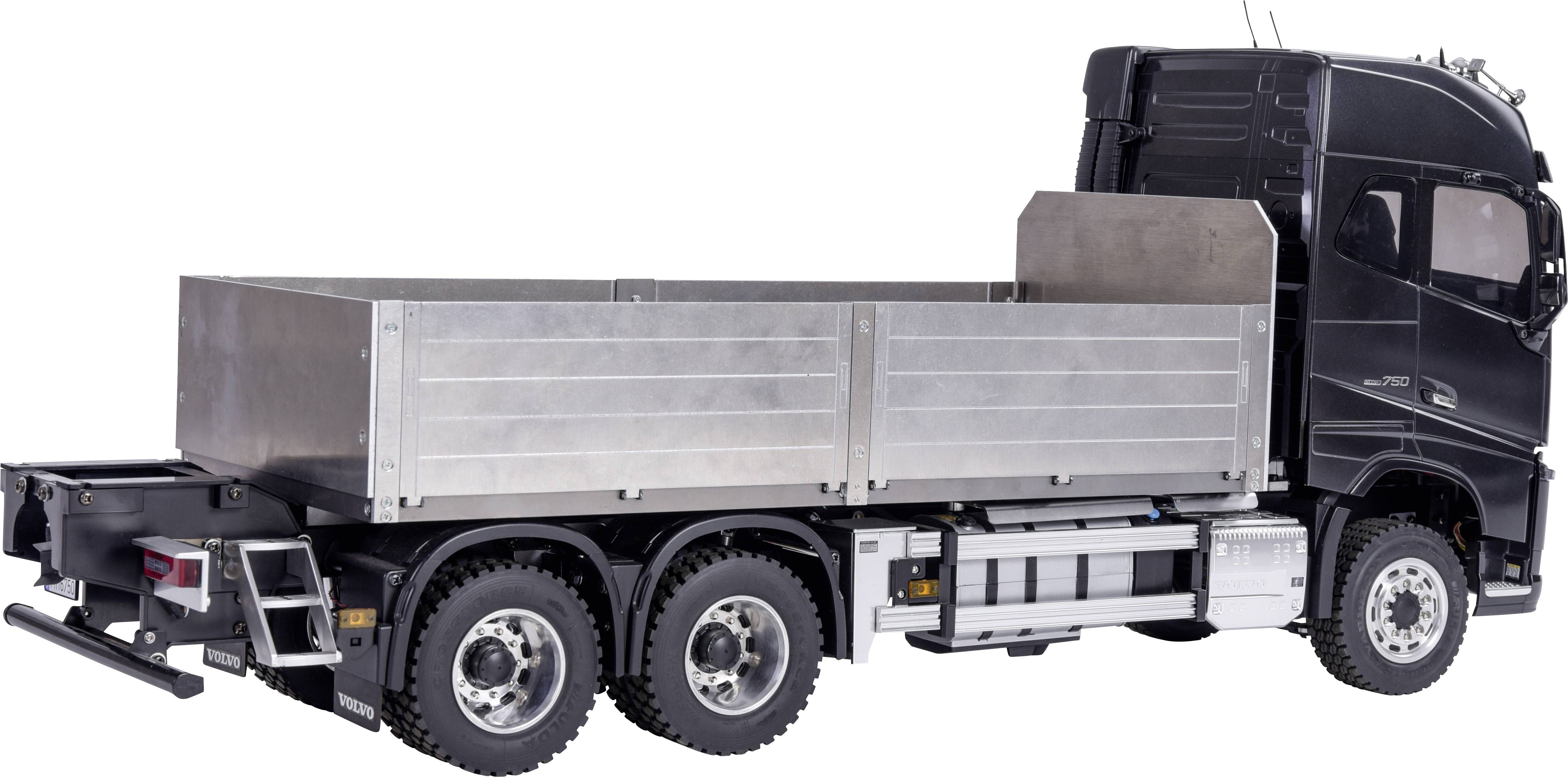 A large black lorry with an open, silver-coloured cargo area. No load present. Right side of the vehicle visible.