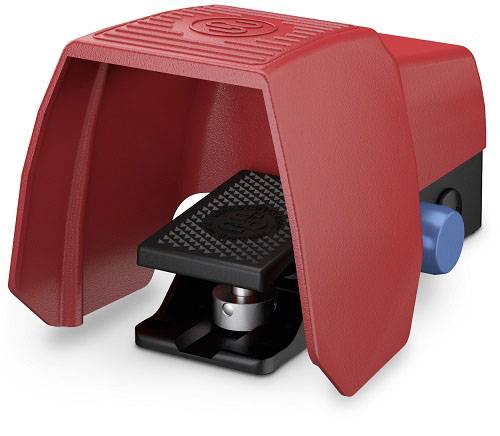 Red foot switch with protective cover, black tread surface, and blue operational element on the side.