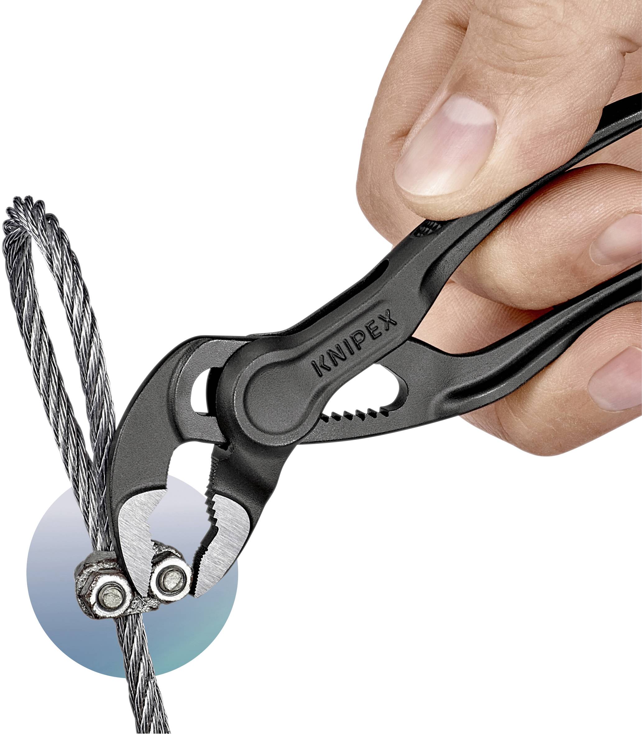 A hand is using pliers to cut a wire rope. The pliers are gripping the rope at two points.