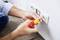 A person is repairing a wall socket with a screwdriver. The screws are being adjusted. These are electrical works.