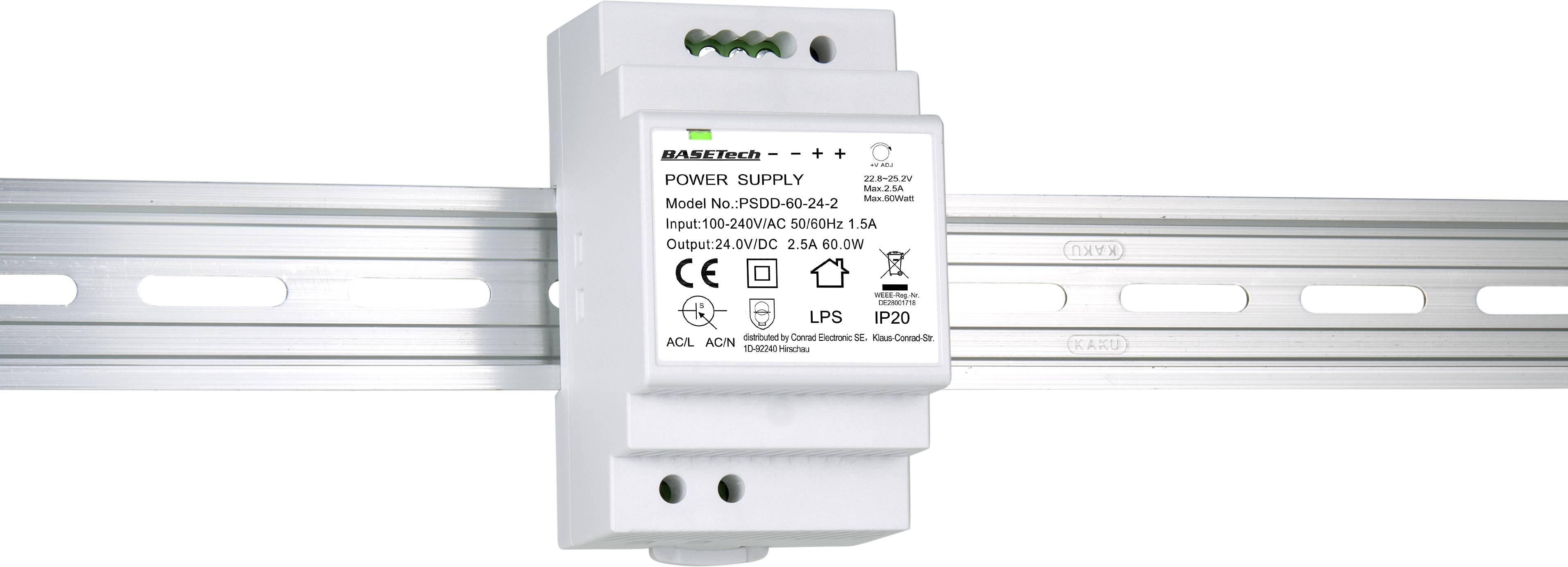 Power supply unit mounted on a DIN rail. White housing with technical specifications on a label at the front.