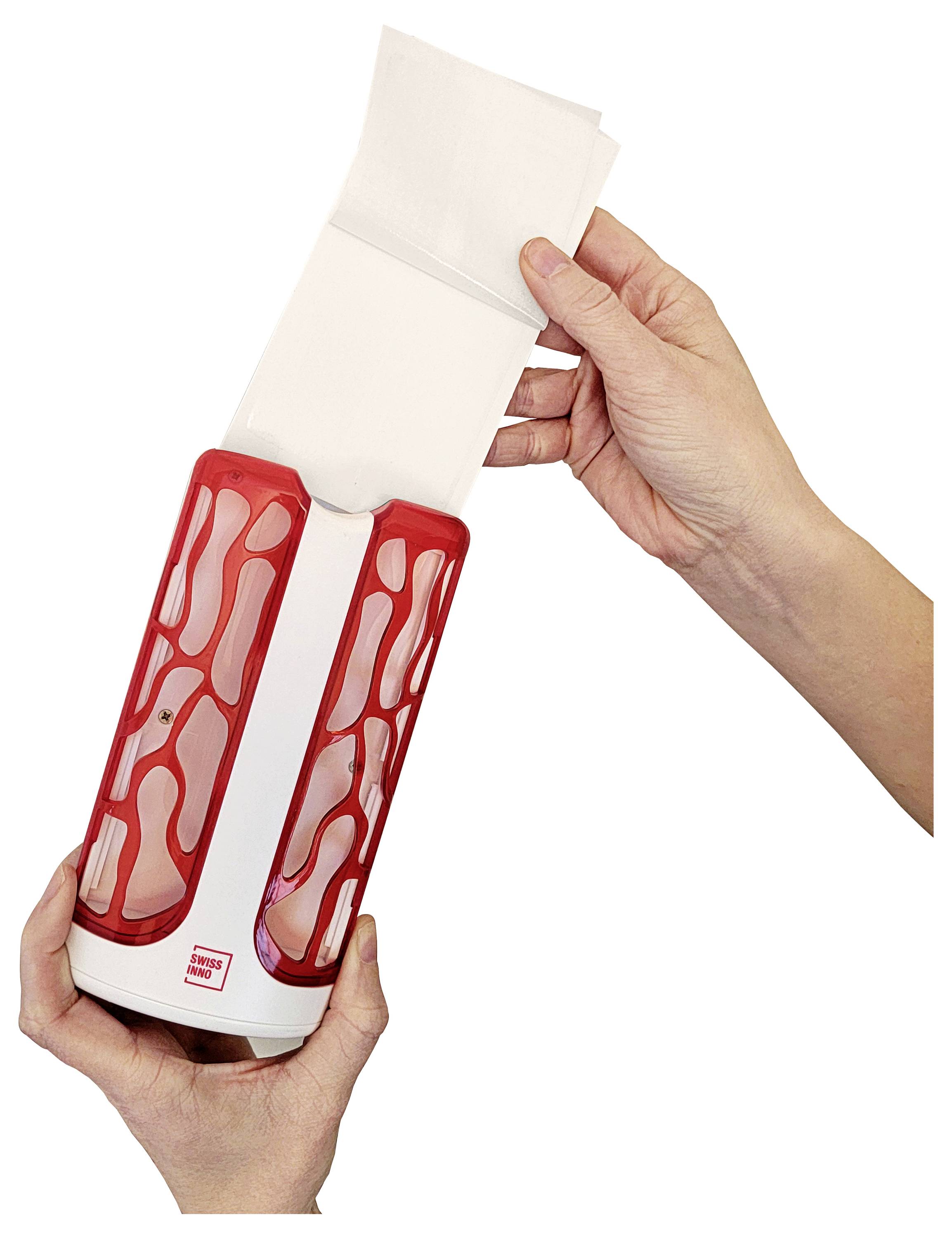 Two hands holding a red and white napkin dispenser, removing a white napkin.