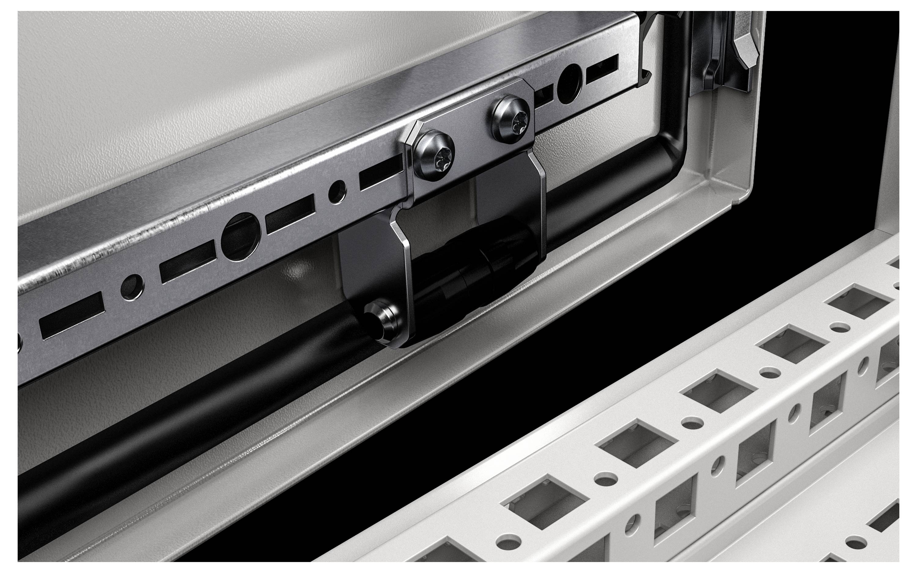 Close-up of a metal profile with a bolted bracket. A black cable is visible in the background, routed through the bracket.