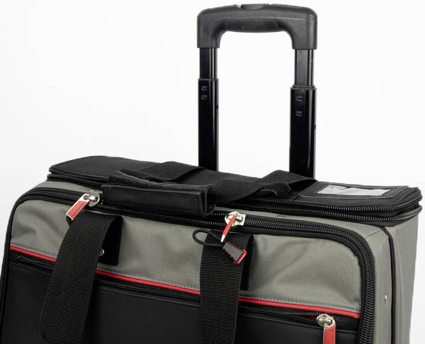 A black and grey rolling suitcase with an extendable handle, with red detailing on the zips and carry handles.