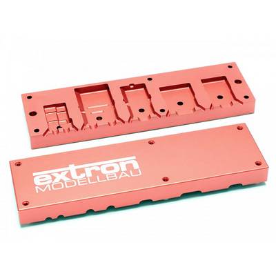 Two red metal components, one with the inscription 'extron MODEL MAKING'.<br><br>Note: I've used "Model Making" as a more British English translation of "Modellbau", which is a direct equivalent of the term in British English.